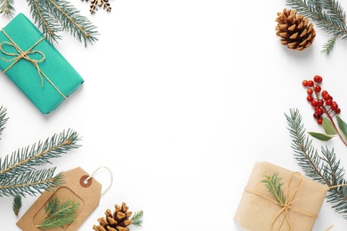 Flat lay composition with Christmas gifts and festive decor on white background. Space for text