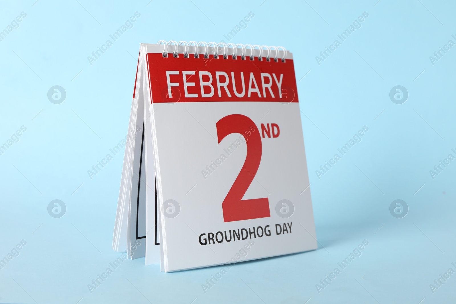 Photo of Calendar with date February 2nd on light blue background. Groundhog day