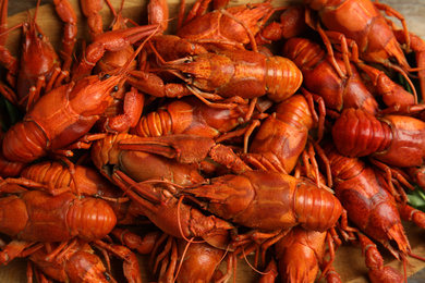 Delicious boiled crayfishes on table, closeup view