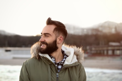 Photo of Portrait of stylish young man near sea