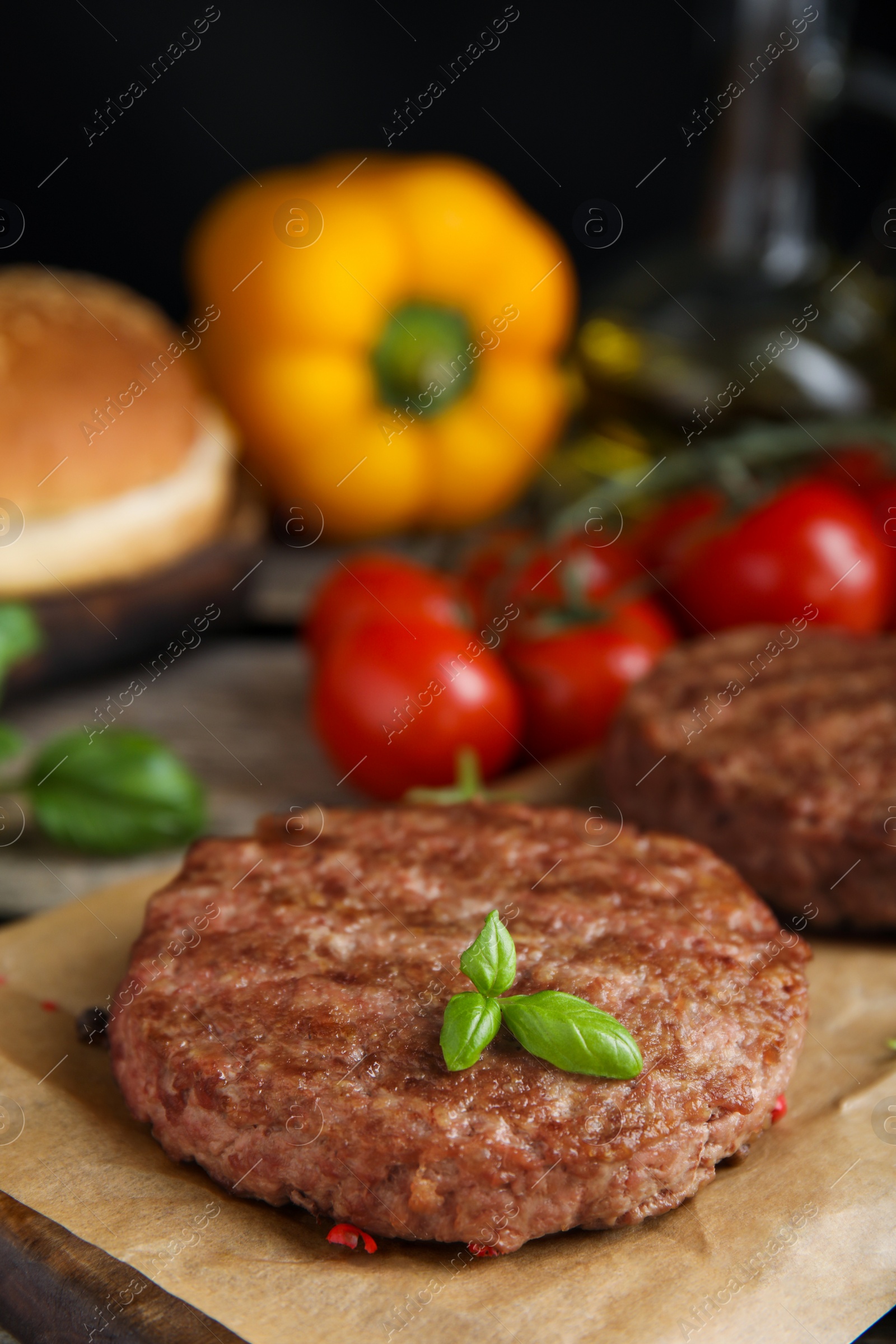 Photo of Tasty grilled hamburger patties with basil served on table, closeup