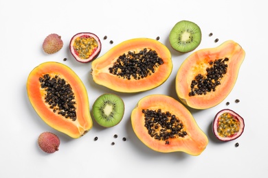 Photo of Fresh ripe papaya and other fruits on white background, top view