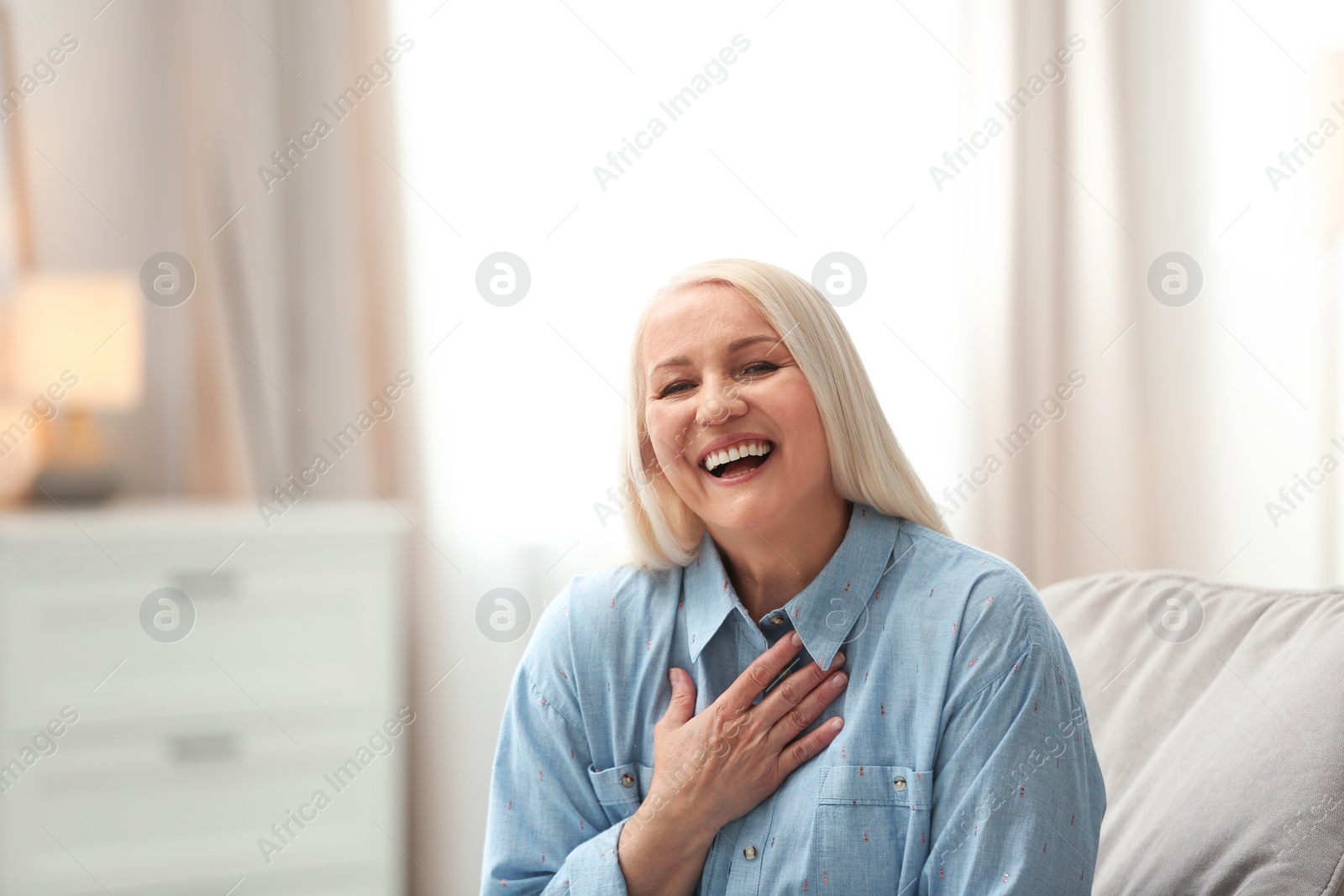 Photo of Portrait of happy mature woman at home