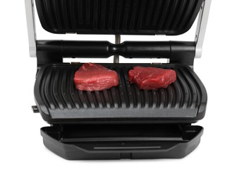Photo of Electric grill with raw meat steaks isolated on white