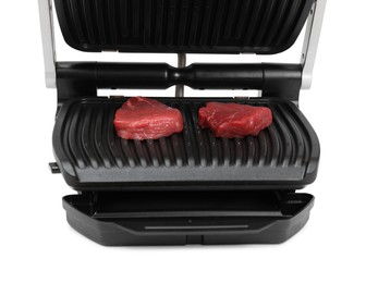 Electric grill with raw meat steaks isolated on white