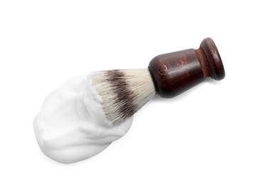 Shaving brush and foam on white background, top view