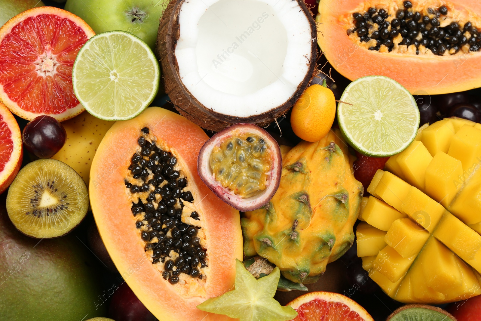 Photo of Many different delicious exotic fruits as background, top view