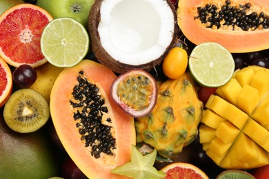 Many different delicious exotic fruits as background, top view