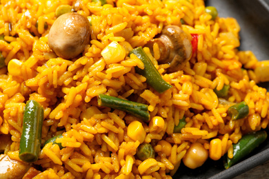 Delicious rice pilaf with vegetables, closeup view