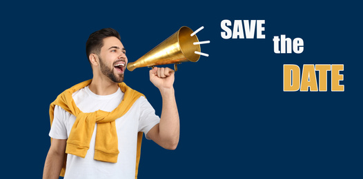 Young man with megaphone and phrase SAVE THE DATE on blue background