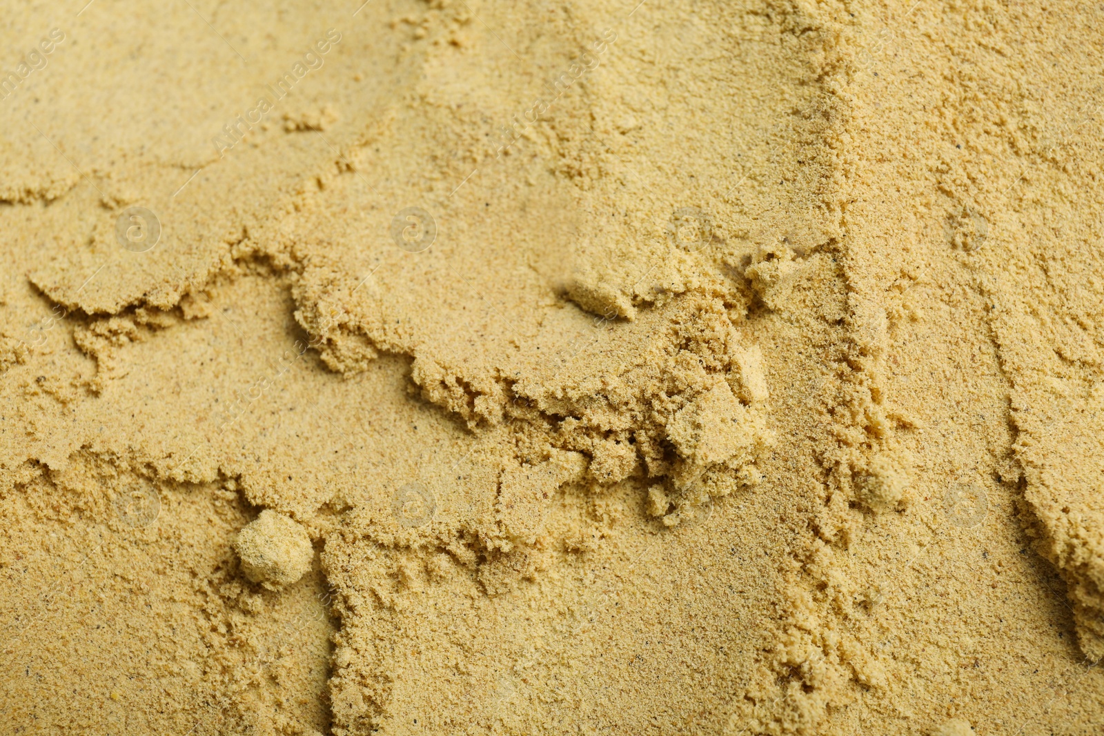 Photo of Aromatic mustard powder as background, top view