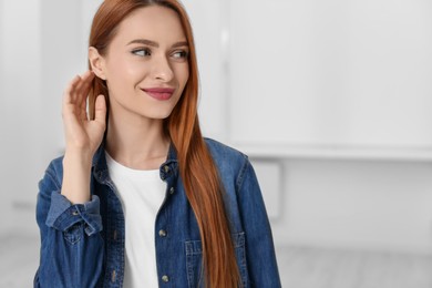 Portrait of beautiful young woman at home, space for text