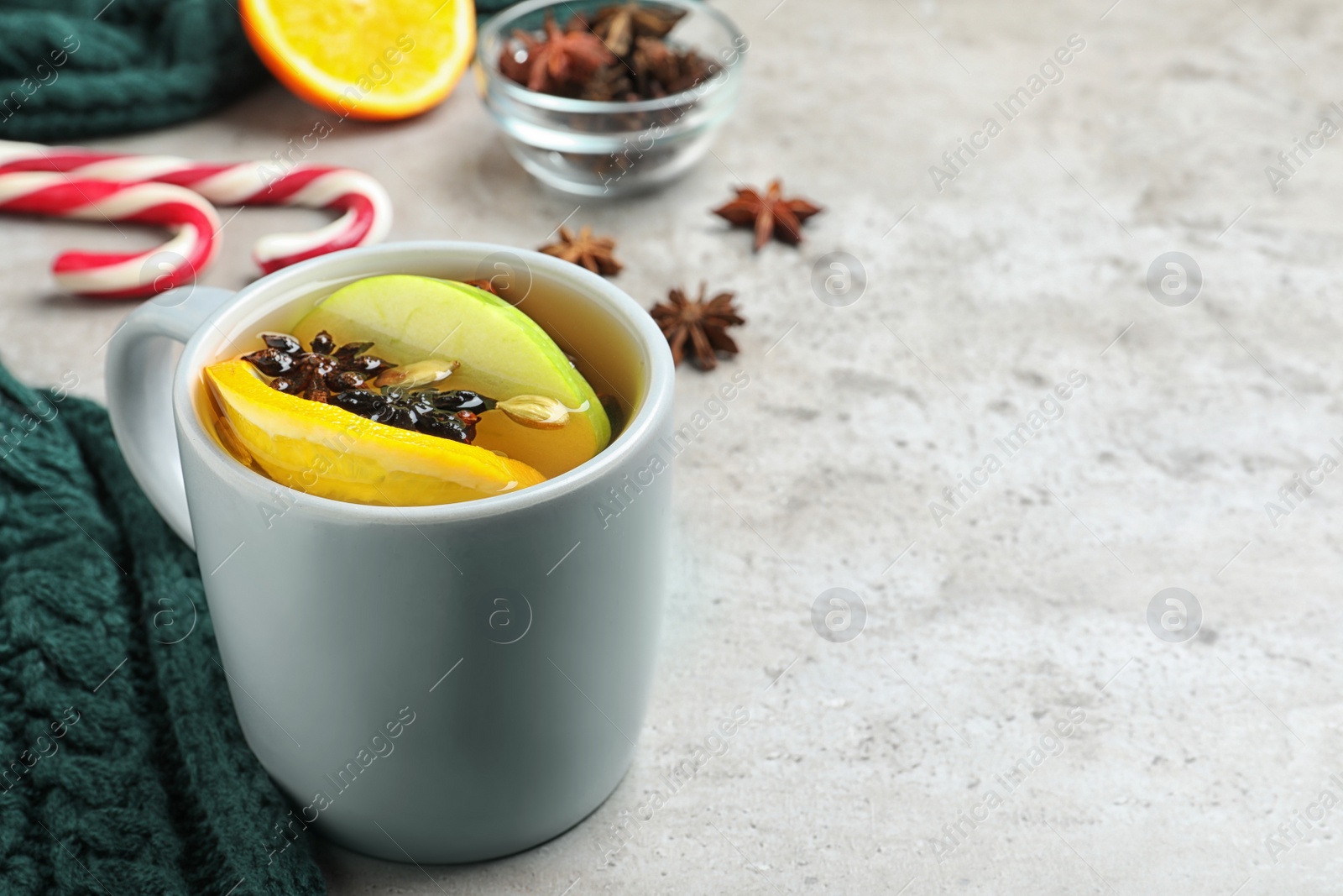 Photo of Aromatic white mulled wine on light grey table. Space for text
