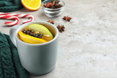 Aromatic white mulled wine on light grey table. Space for text