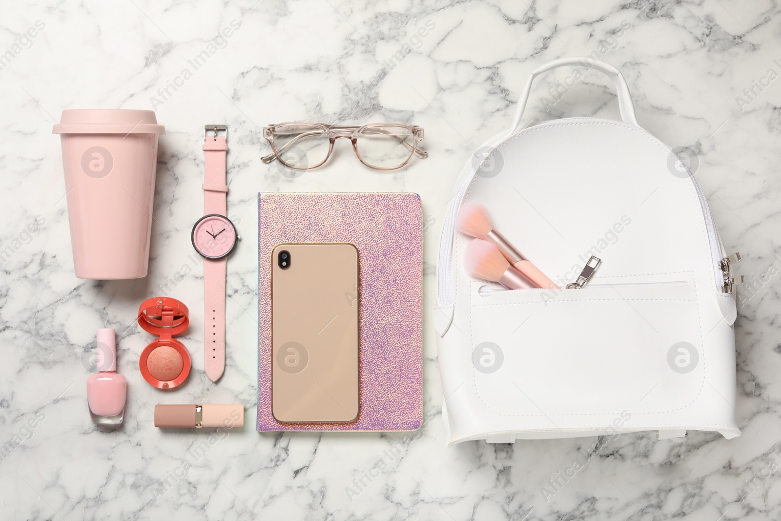 Photo of Stylish urban backpack and different items on white marble table, flat lay