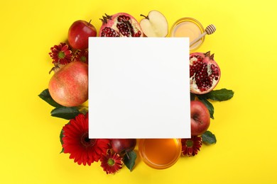 Photo of Flat lay composition with Rosh Hashanah holiday attributes and card on yellow background. Space for text