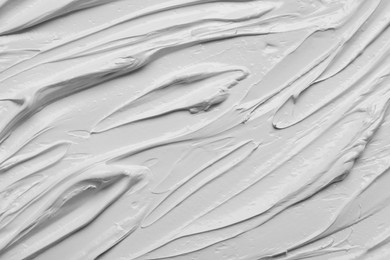 Photo of Strokes of white oil paint as background, closeup