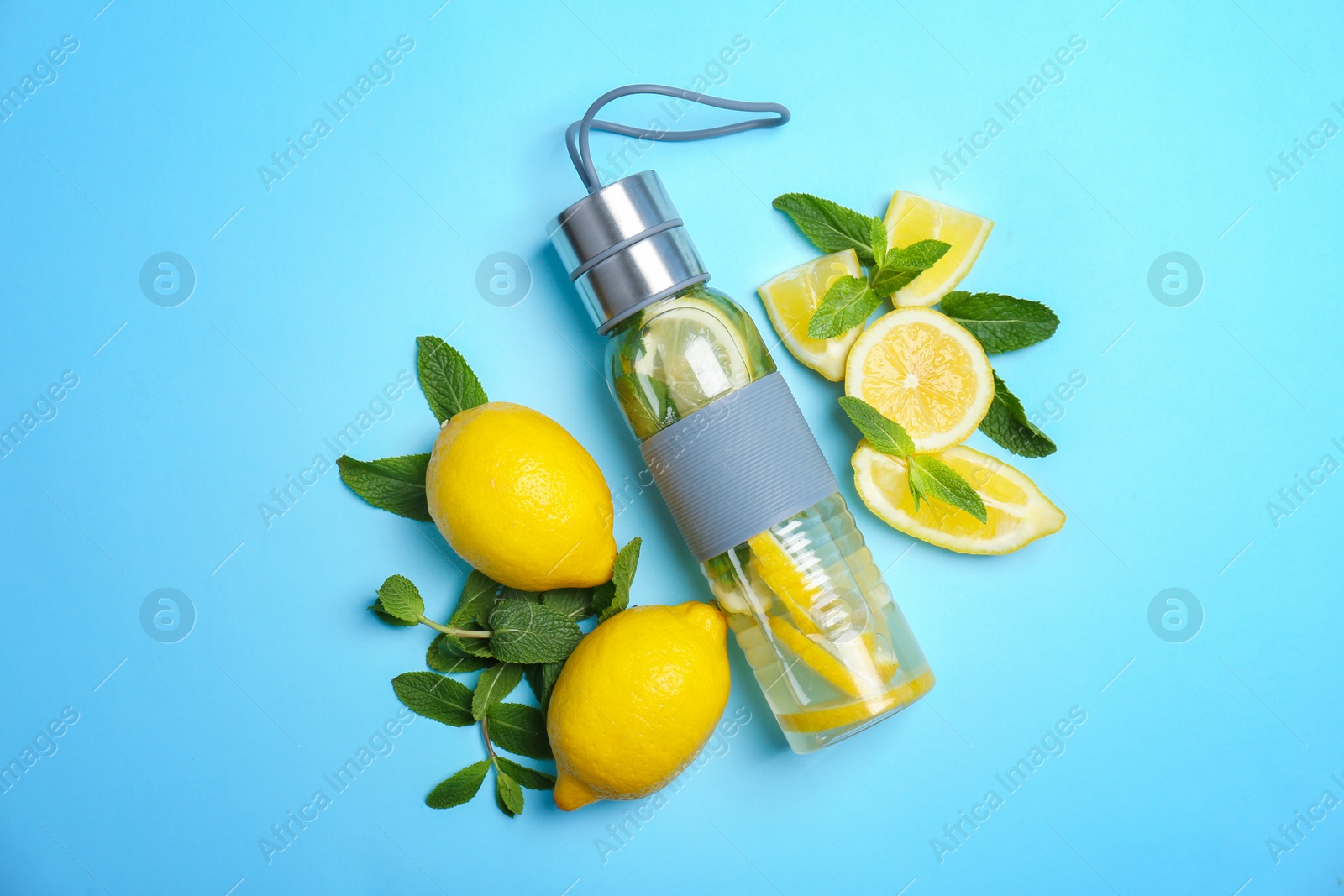 Photo of Flat lay composition with delicious natural lemonade on color background