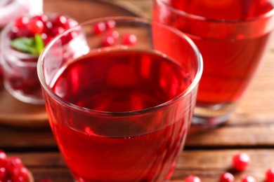 Photo of Tasty cranberry juice in glasses on table, closeup