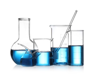 Set of laboratory glassware with blue liquid isolated on white