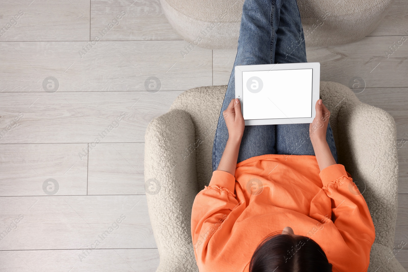 Photo of Woman working with tablet in armchair, top view. Space for text