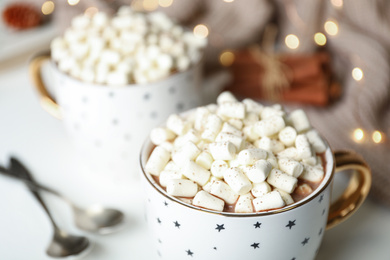 Photo of Delicious cocoa drink with marshmallows on table, closeup