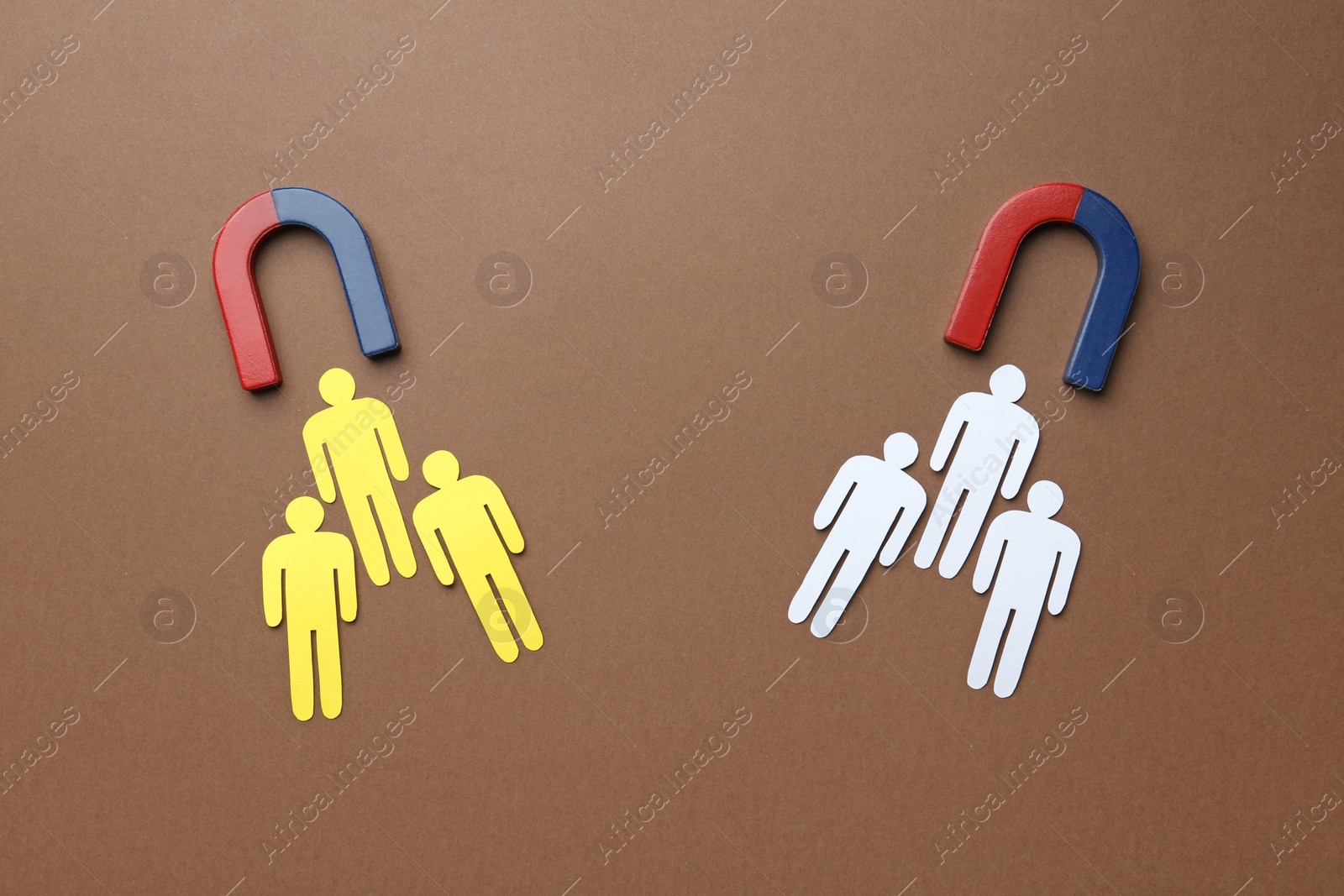 Photo of Magnets attracting paper people on color background, flat lay. Marketing concept