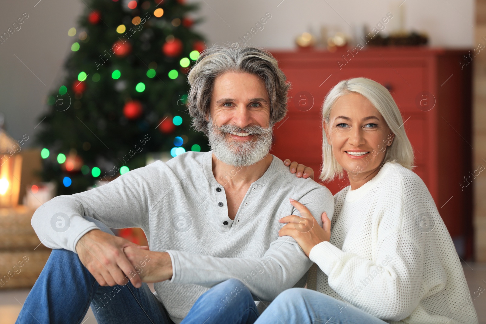 Photo of Happy mature couple celebrating Christmas at home