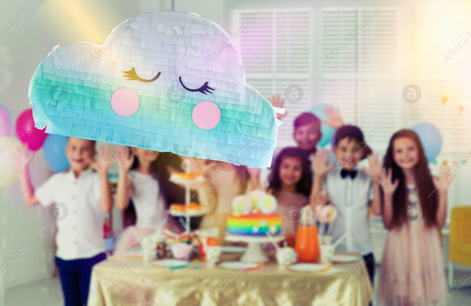 Image of Bright festive pinata hanging indoors at birthday party