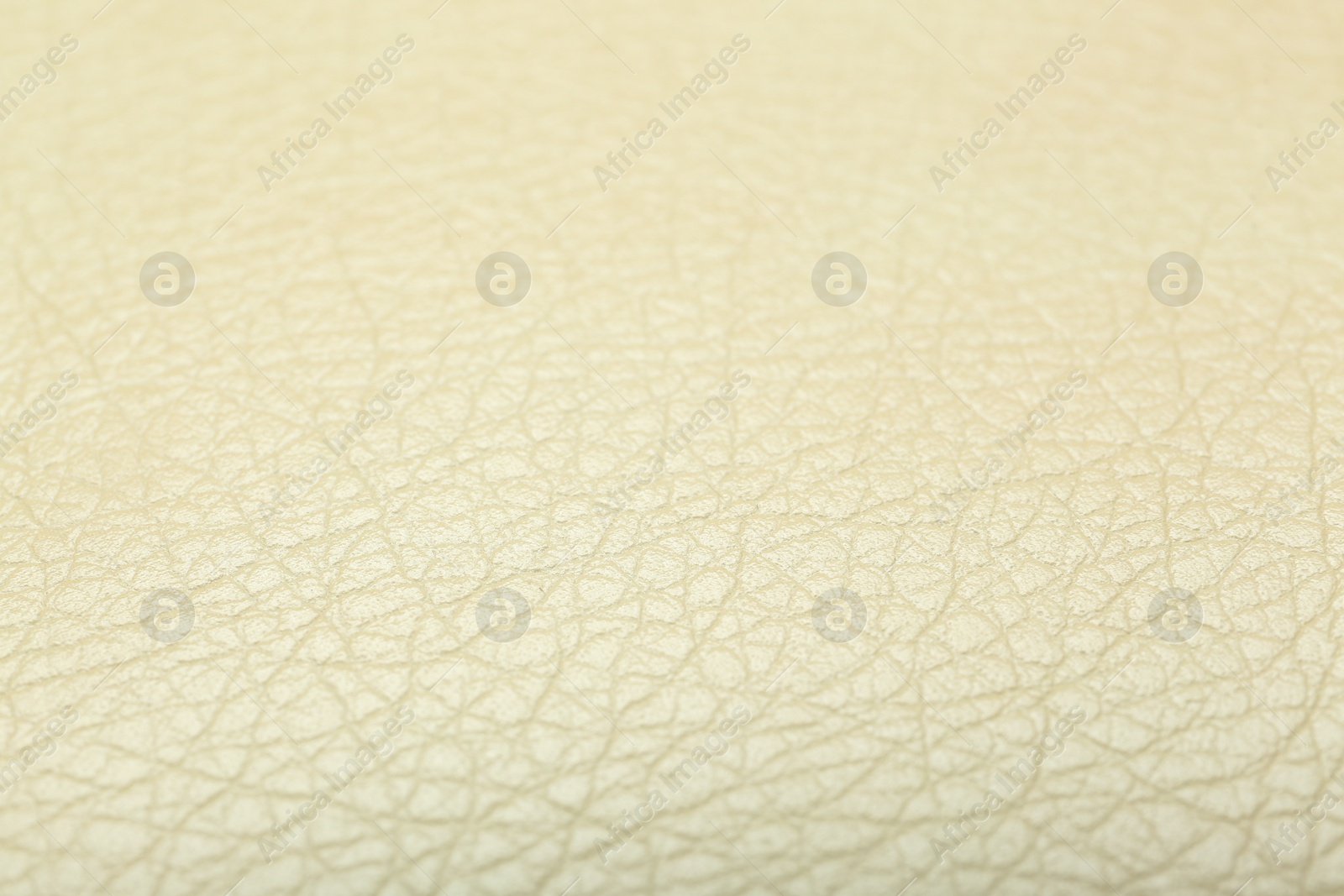 Photo of Texture of beige leather as background, closeup