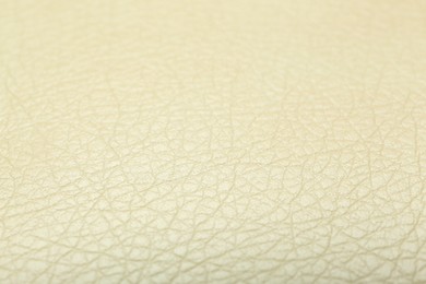 Photo of Texture of beige leather as background, closeup