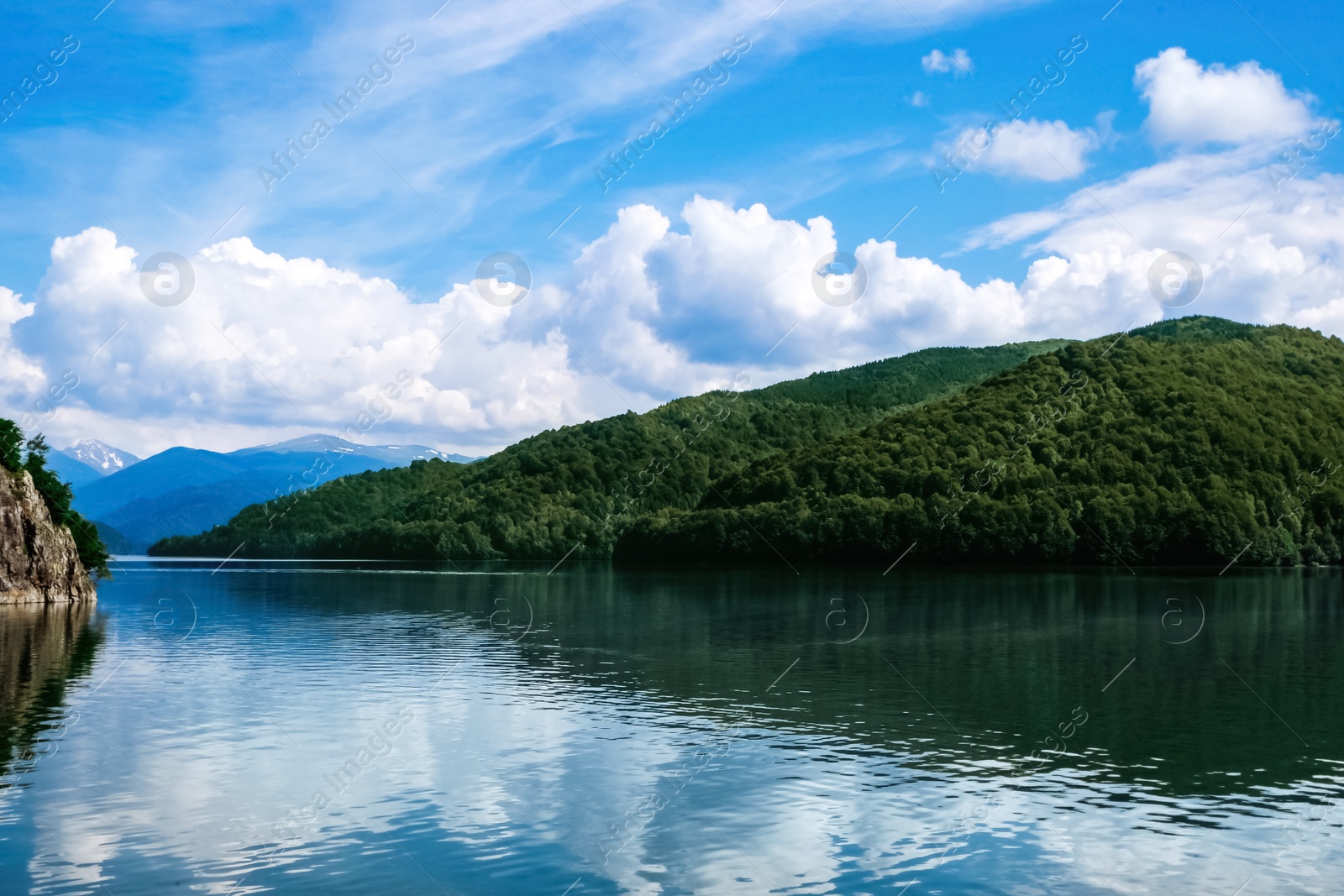 Photo of Picturesque view of beautiful lake surrounded by mountains on sunny day