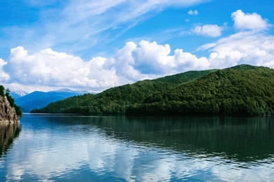 Picturesque view of beautiful lake surrounded by mountains on sunny day