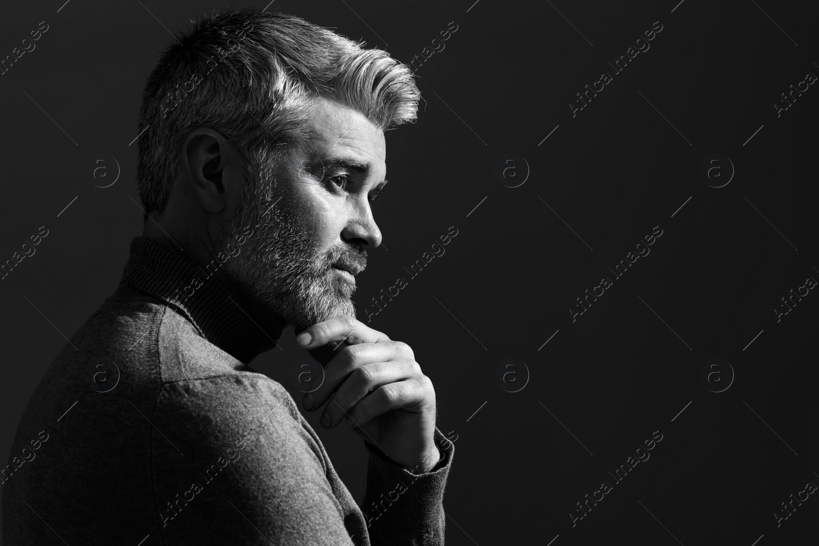 Photo of Portrait of handsome man on dark background, space for text. Black and white effect