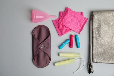 Tampons and other menstrual hygienic products on light grey background, flat lay