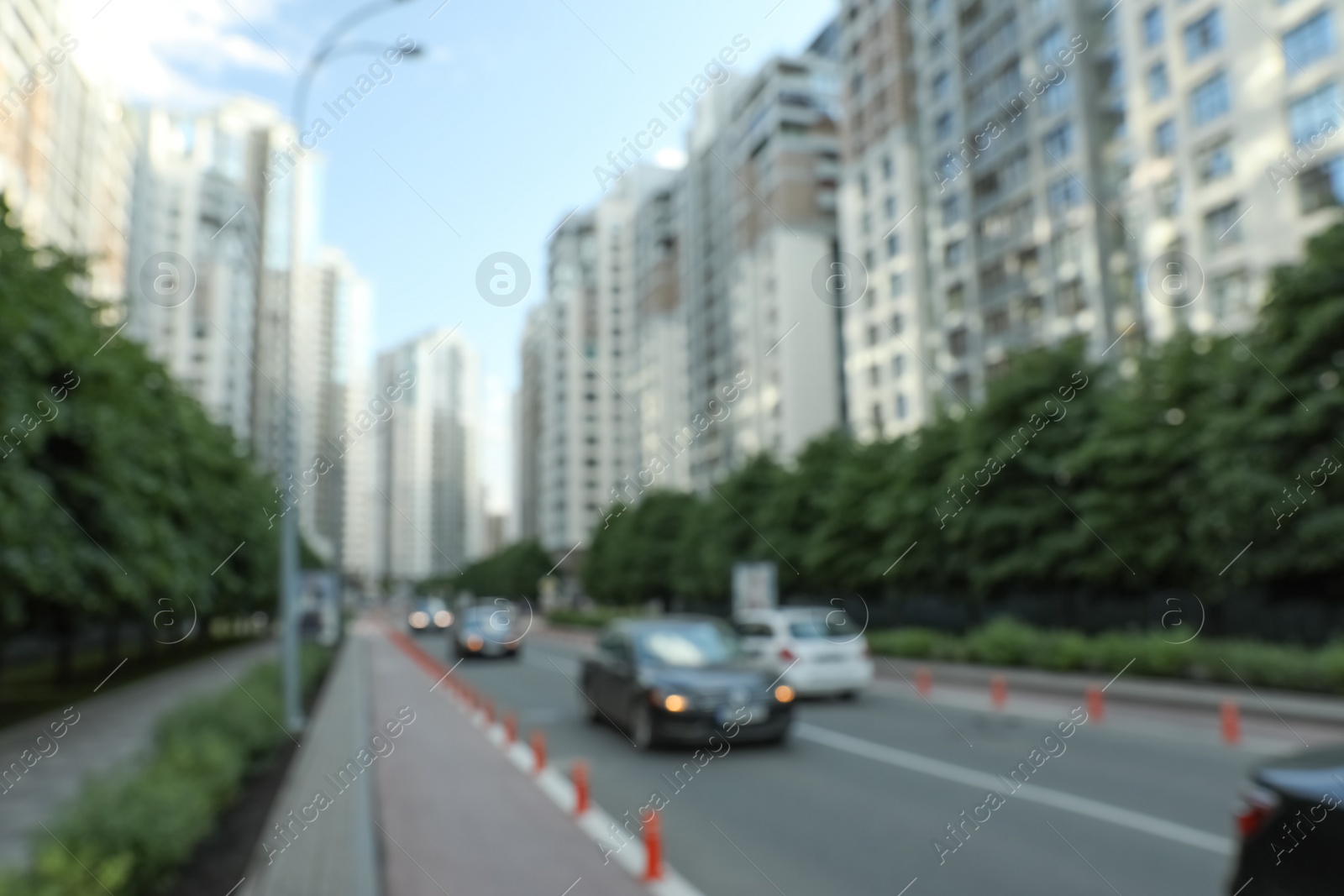 Photo of KYIV, UKRAINE - MAY 21, 2019: Blurred view of modern housing estate in Pecherskyi district on sunny day