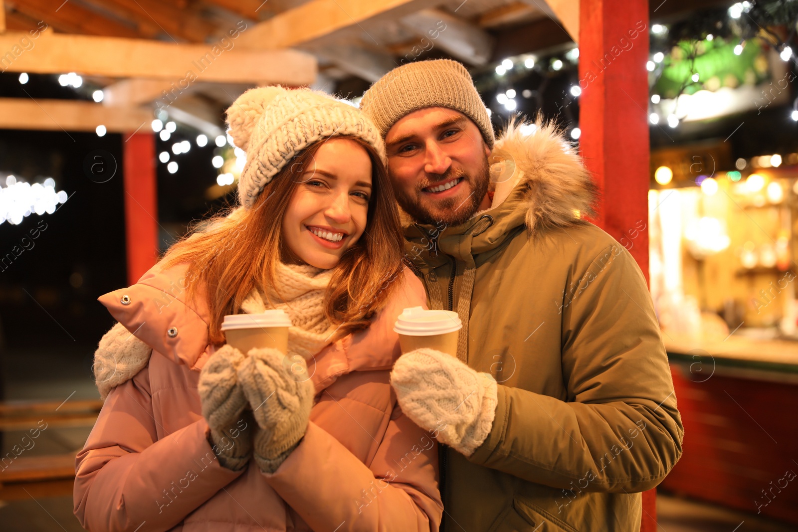 Photo of Happy couple with drinks at Christmas fair