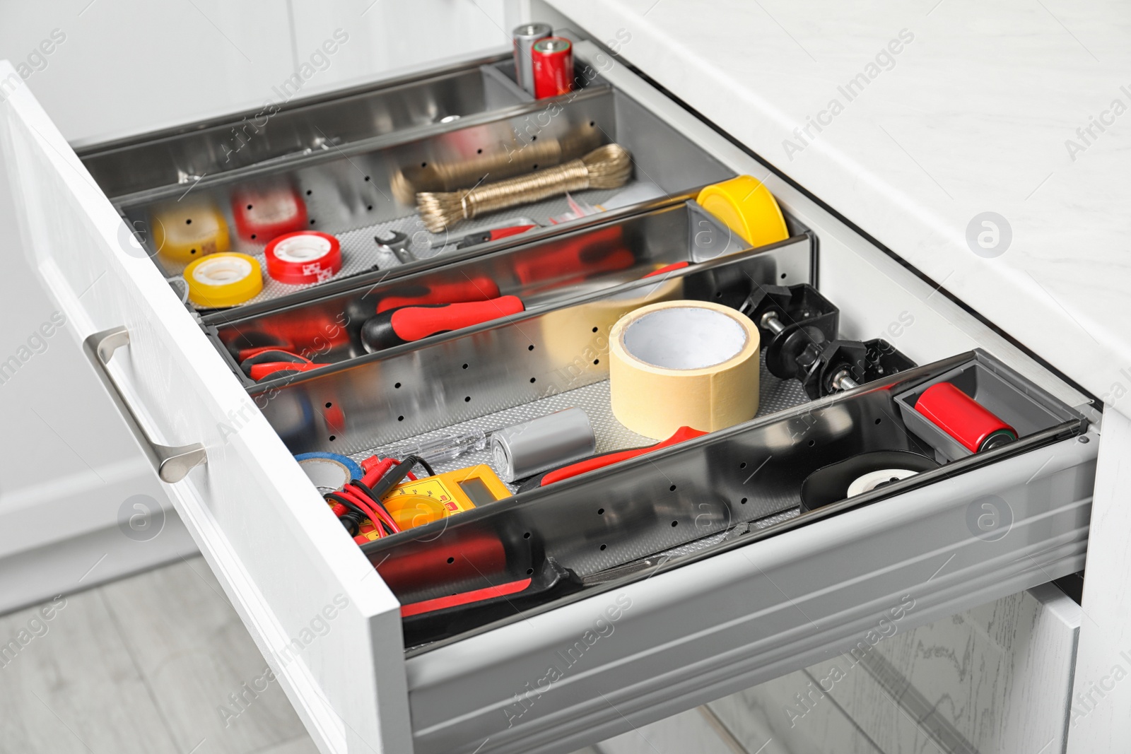 Photo of Set of instruments in open desk drawer indoors