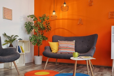 Photo of Interior of modern living room with pillows on sofa