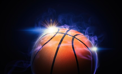 Basketball ball and smoke on black background, closeup. Banner design