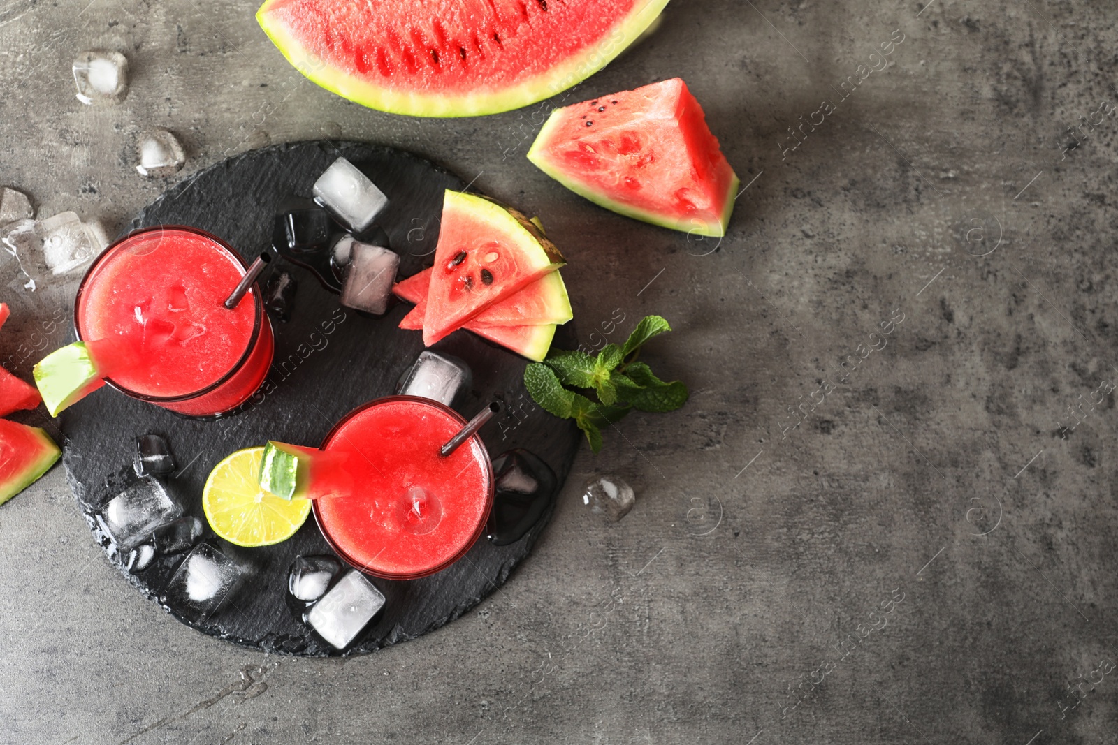 Photo of Tasty summer watermelon drink in glasses and space for text on table, top view