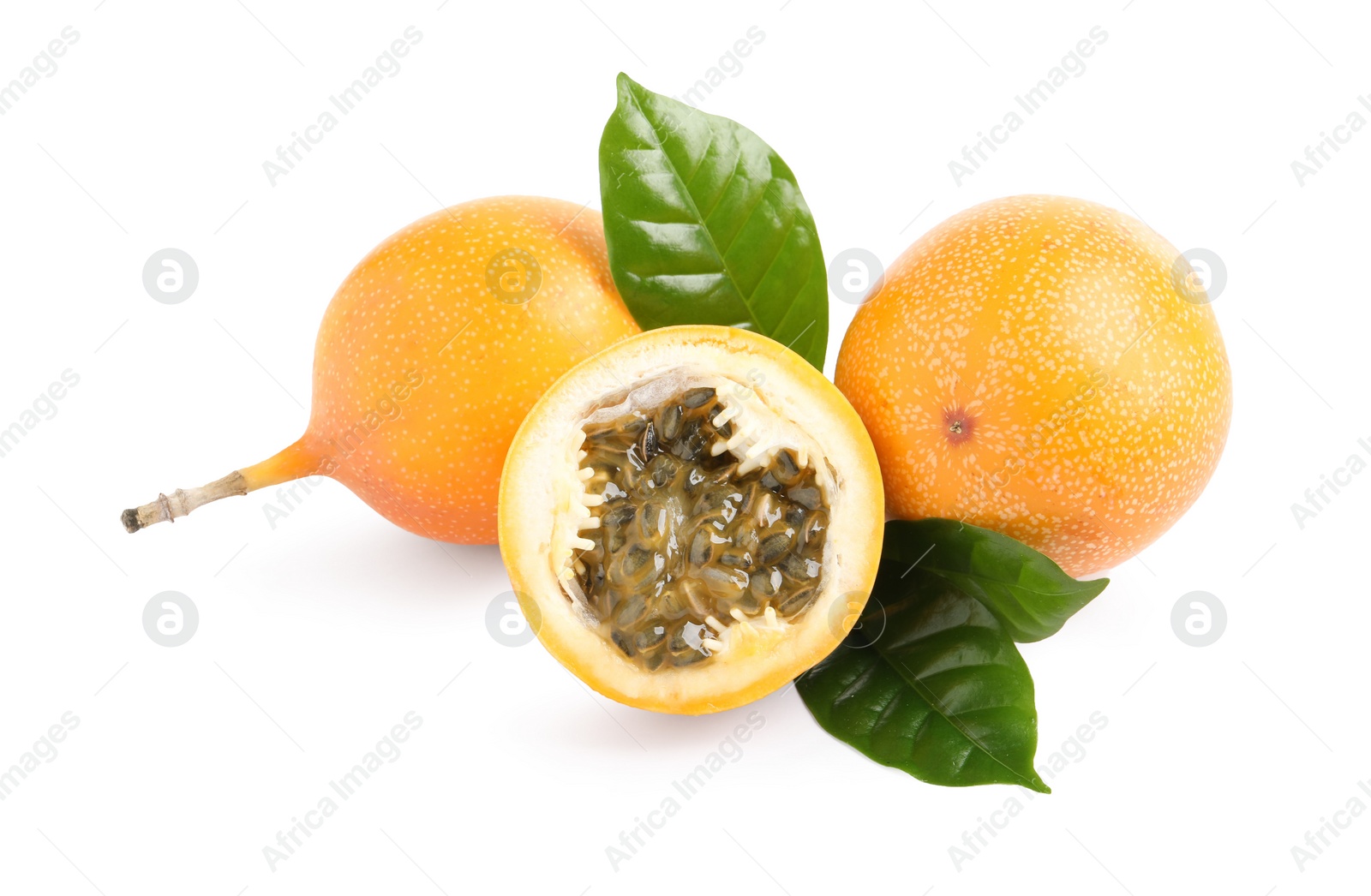 Photo of Whole and cut delicious ripe granadillas with leaves on white background