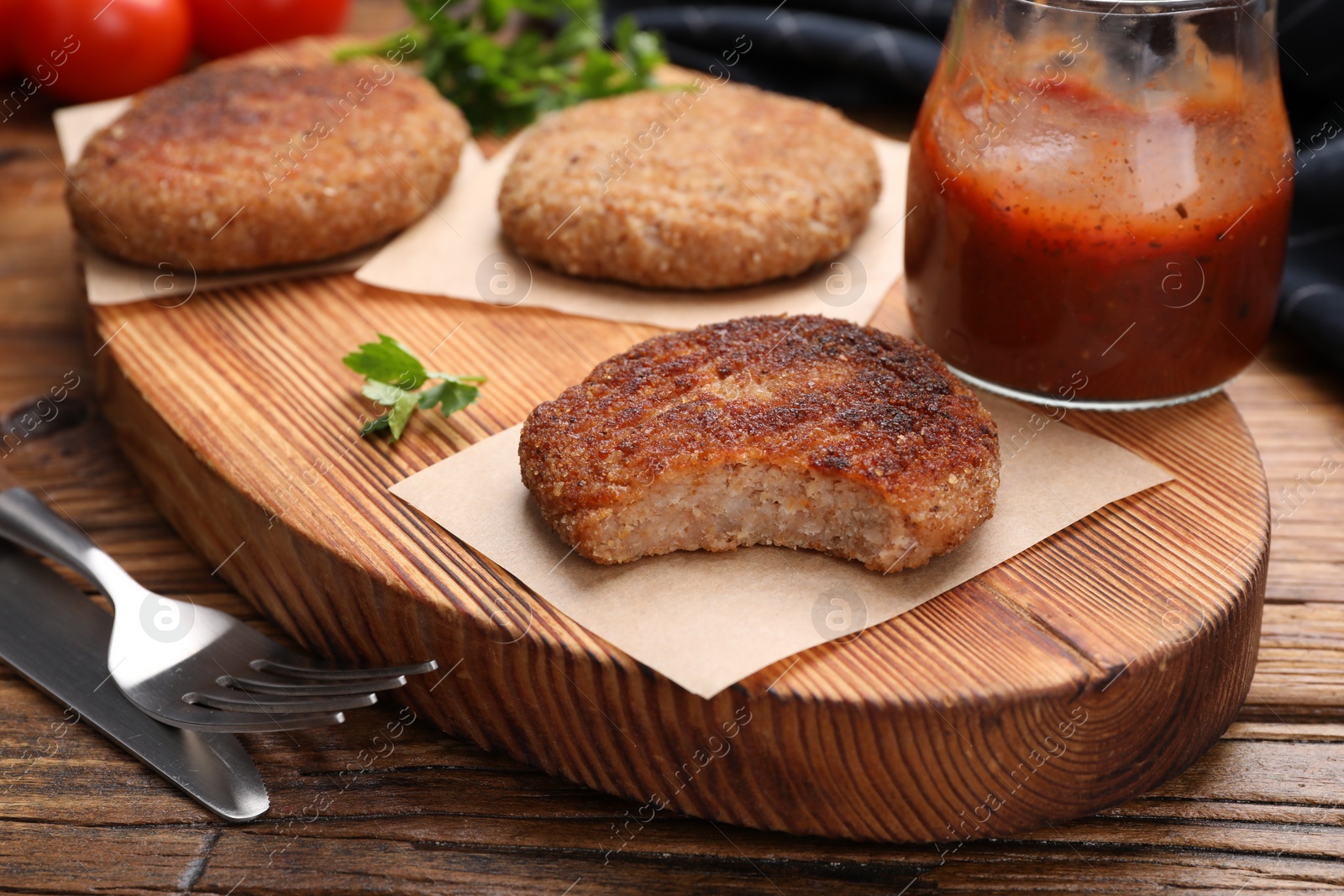 Photo of Delicious vegan cutlets on wooden table, closeup