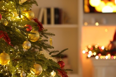 Beautiful decorated Christmas tree with baubles and festive lights indoors, space for text
