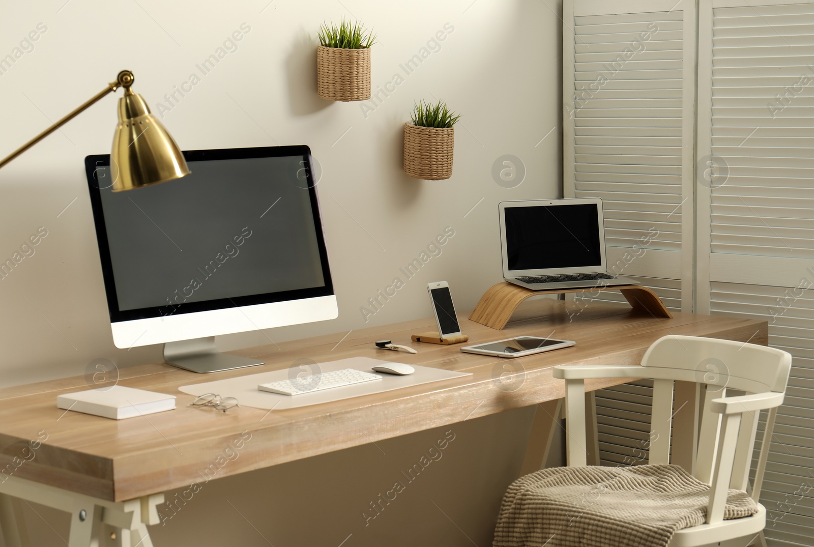 Photo of Stylish workplace interior with modern computer on table. Mockup for design
