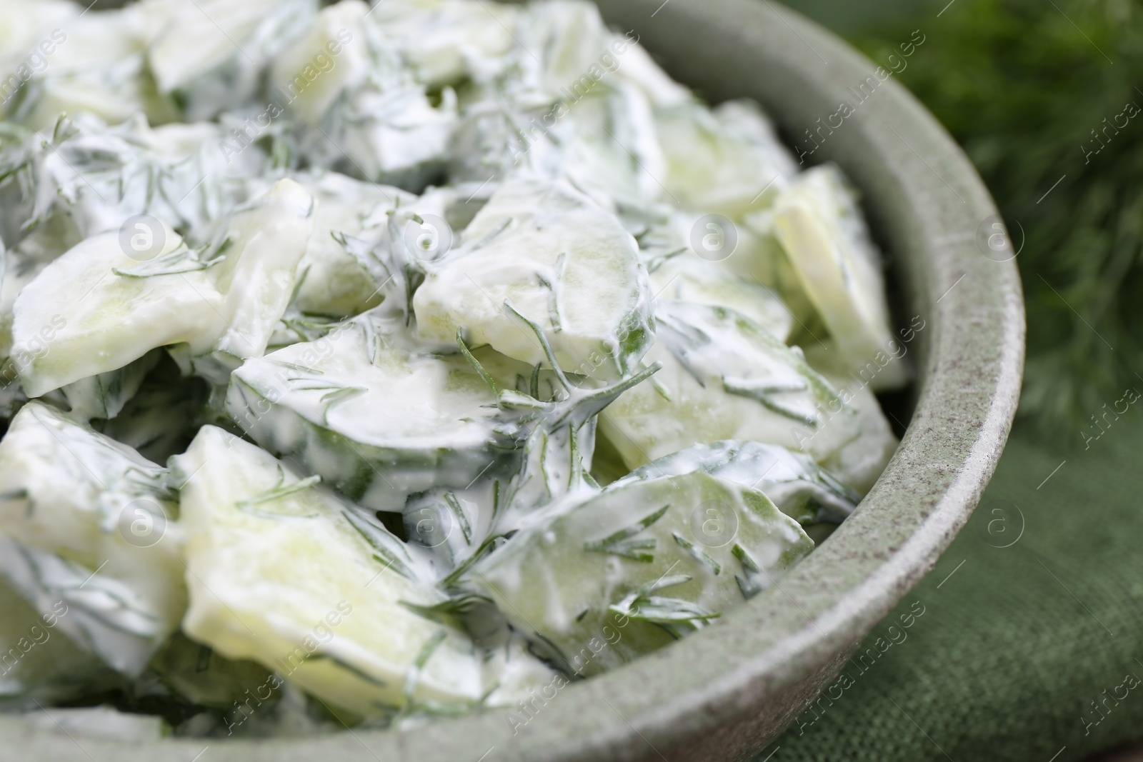 Photo of Delicious cucumber salad in bowl, closeup view