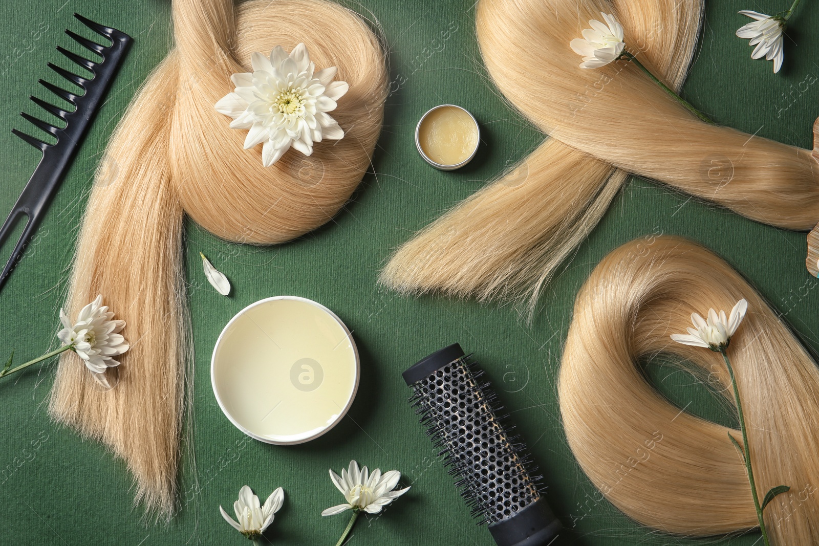 Photo of Composition with locks of blond hair and flowers on color background, top view