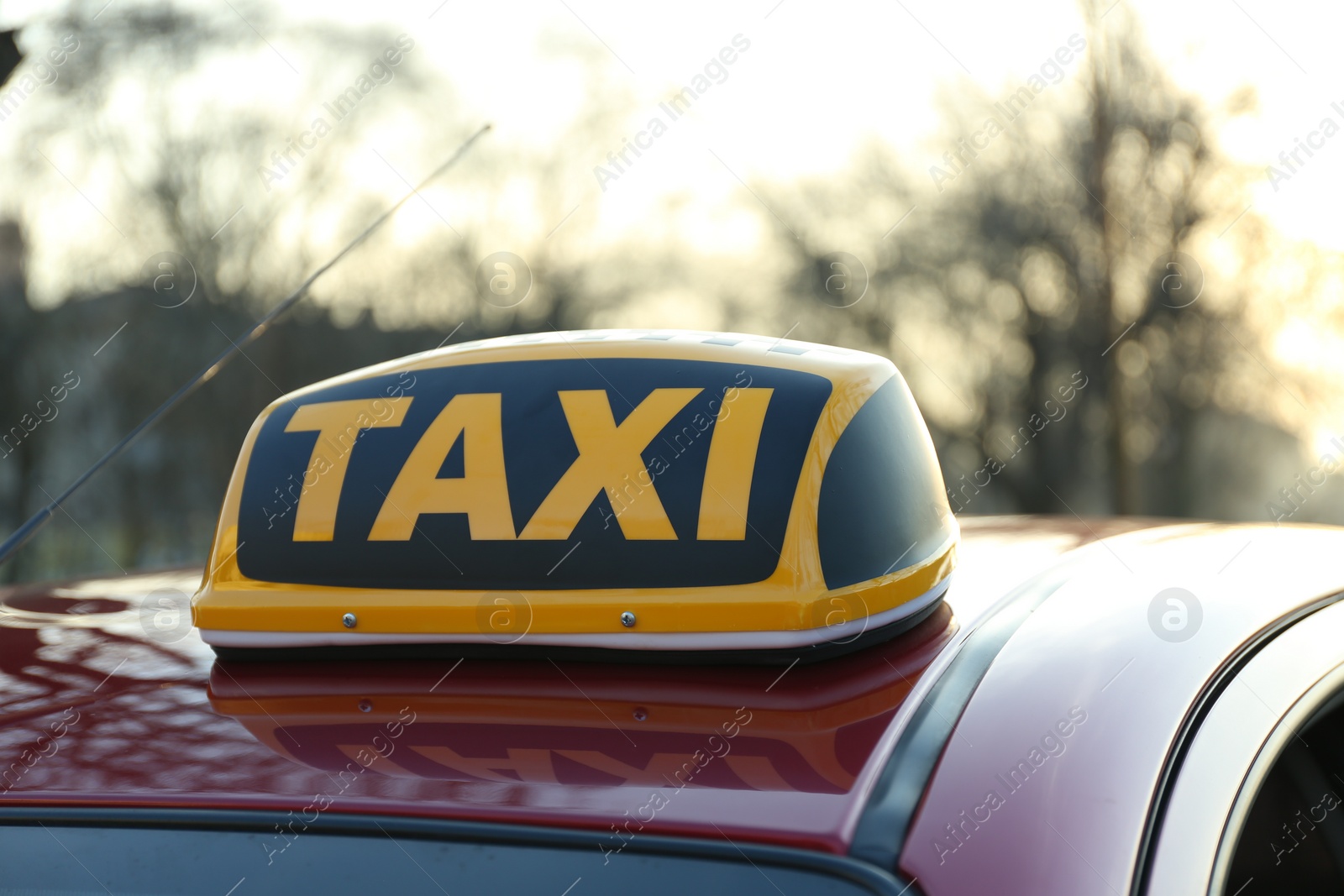 Photo of Roof light with word TAXI on car outdoors