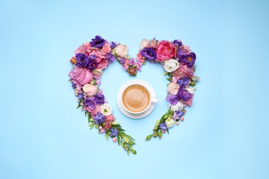Photo of Beautiful heart shaped floral composition with cup of coffee on turquoise background, flat lay