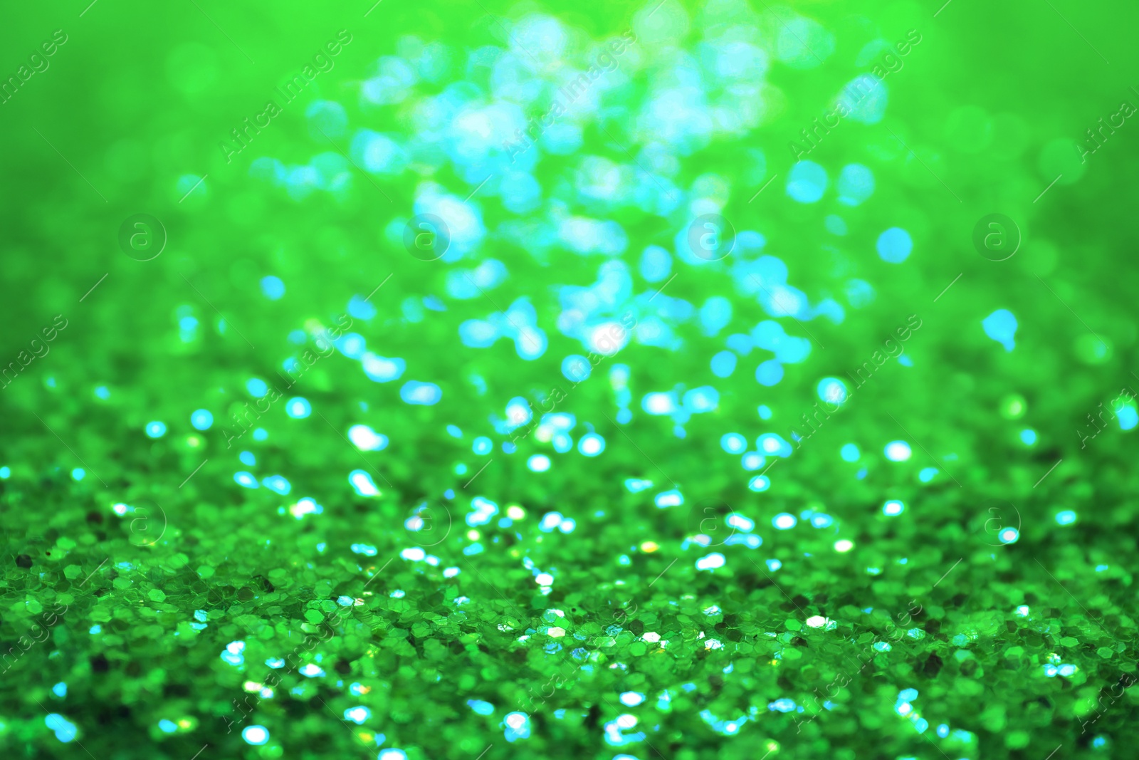 Image of St. Patrick day. Shiny green glitter, closeup. Bokeh effect